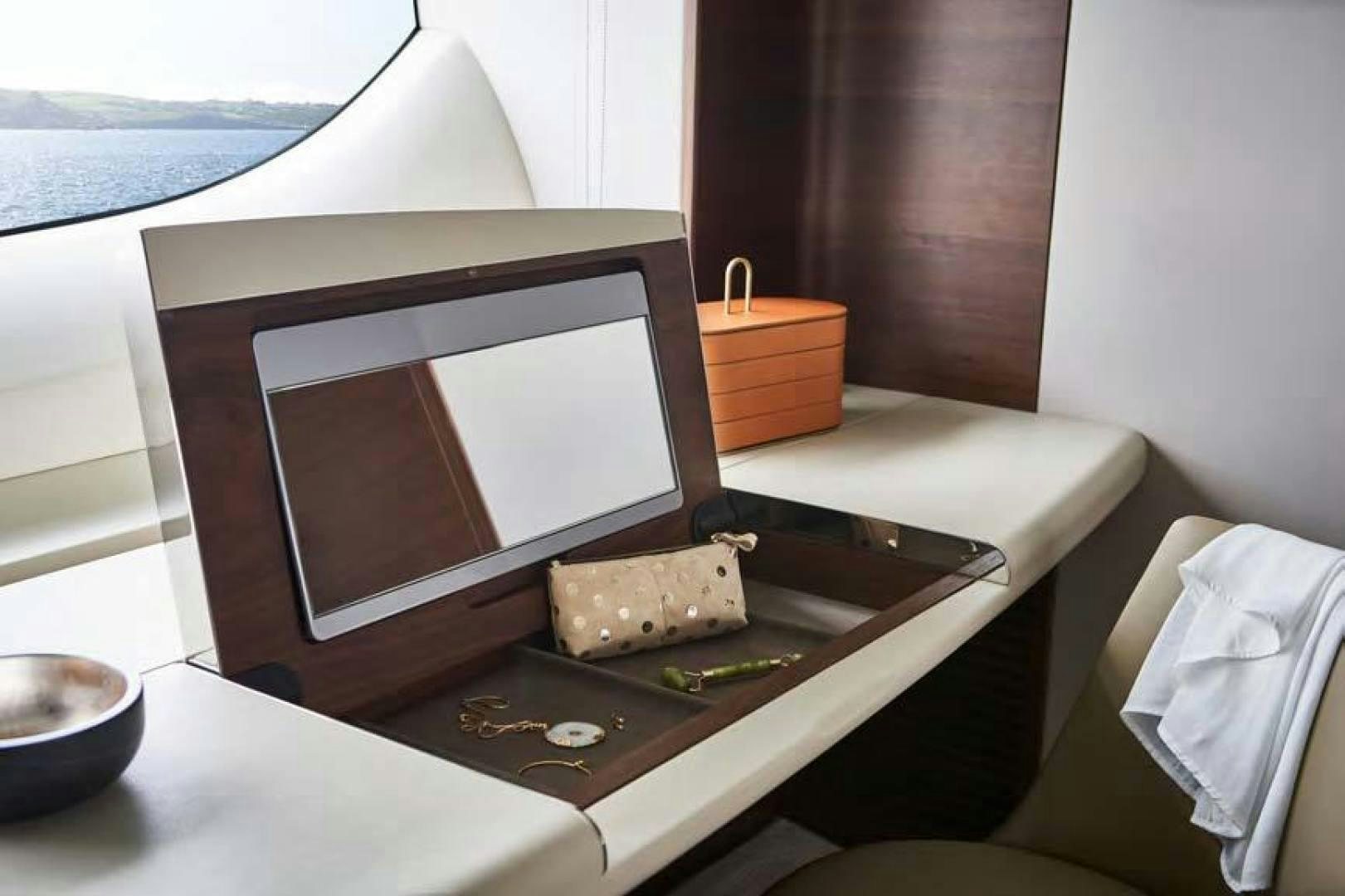 a laptop on a table aboard Y85 Yacht for Sale