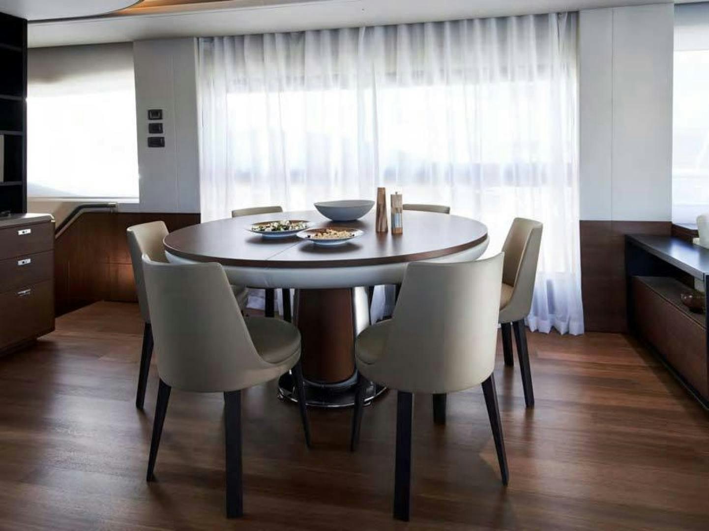 a table with chairs around it aboard Y85 Yacht for Sale