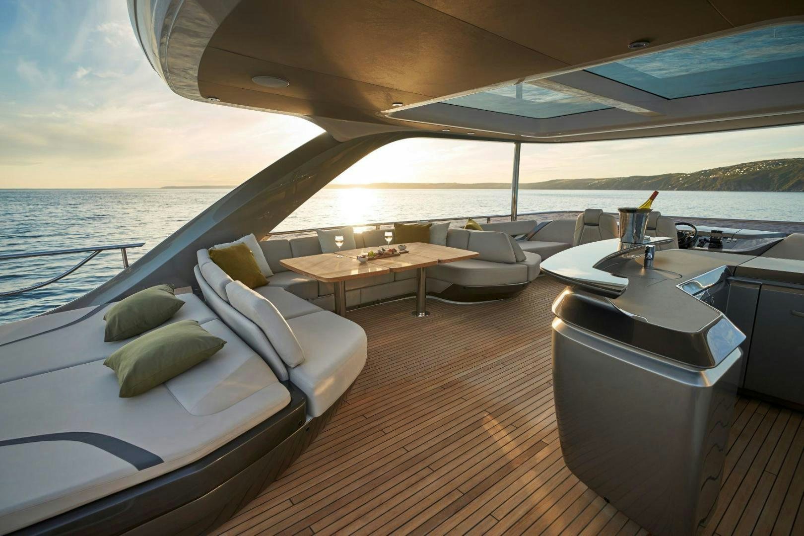 a room with a large bed and a table with chairs on it aboard Y85 Yacht for Sale