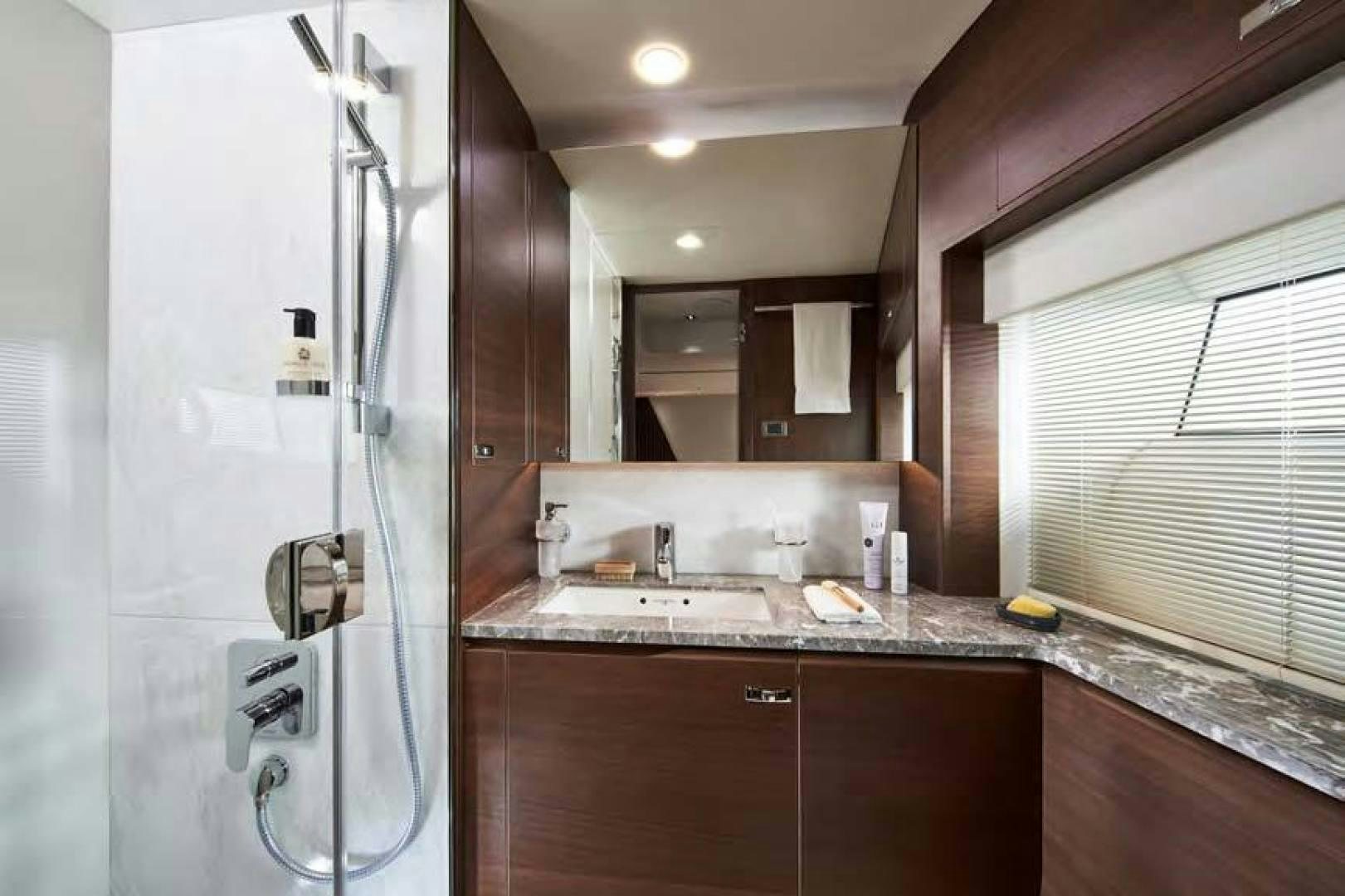 a bathroom with a shower unit and sink aboard Y85 Yacht for Sale