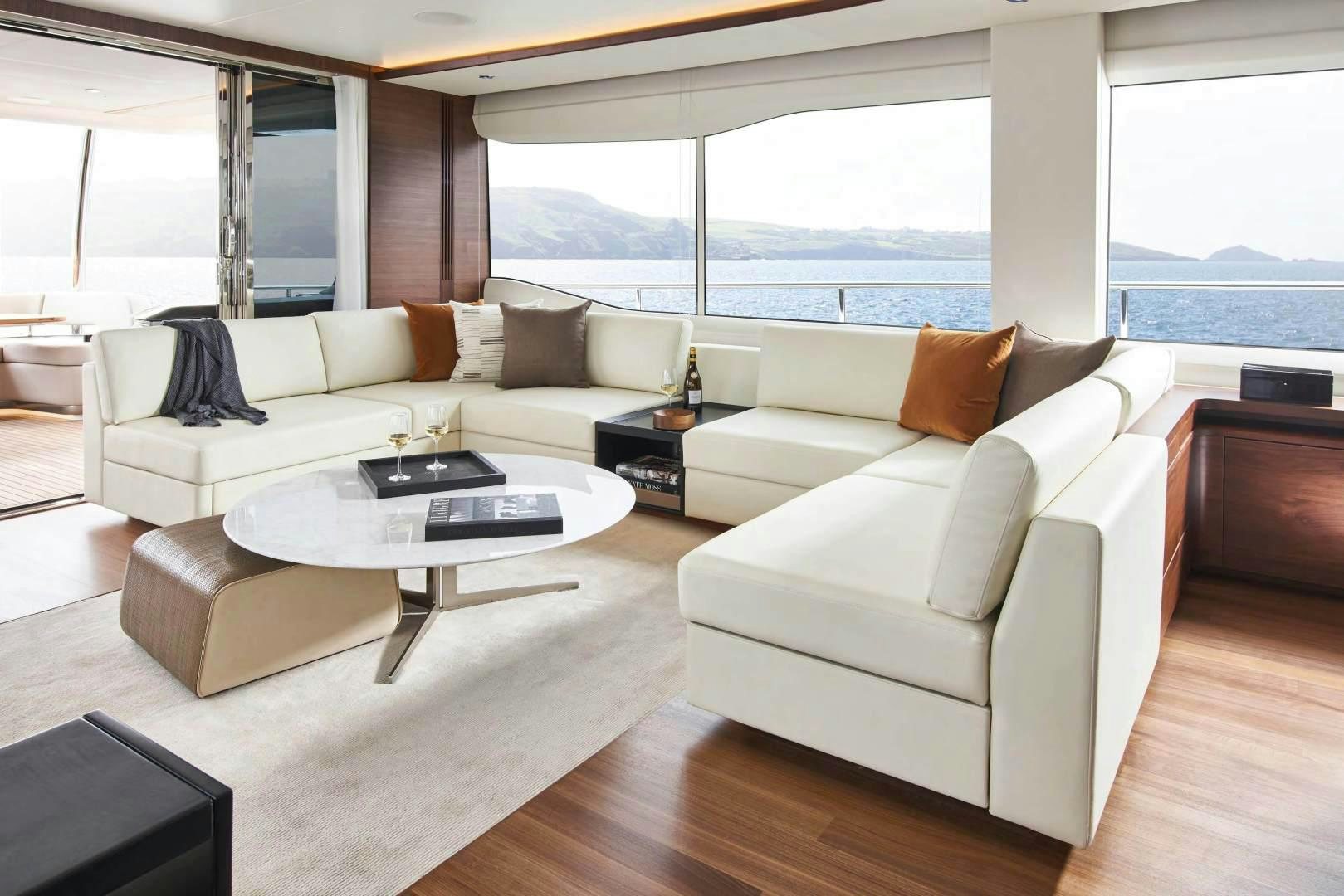 a living room with a large window aboard Y85 Yacht for Sale