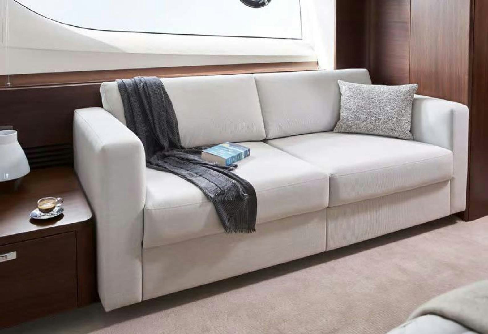 a couch with a pillow on it aboard Y85 Yacht for Sale