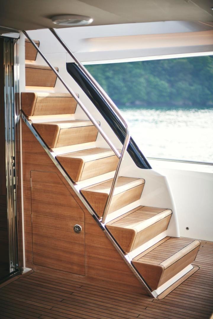 a stack of books on a table aboard Y85 Yacht for Sale