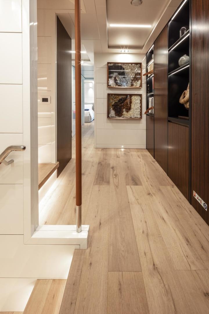 a room with wood floors and wood cabinets aboard ATOM Yacht for Sale