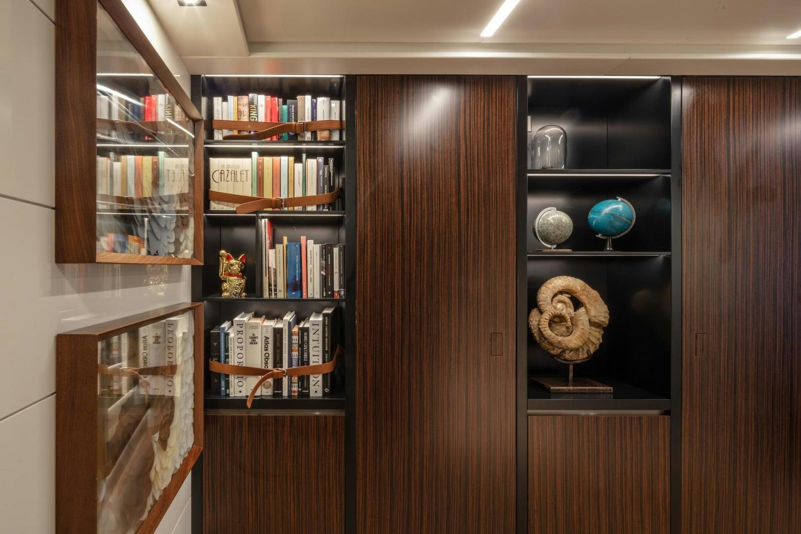 a wooden cabinet with shelves aboard ATOM Yacht for Sale