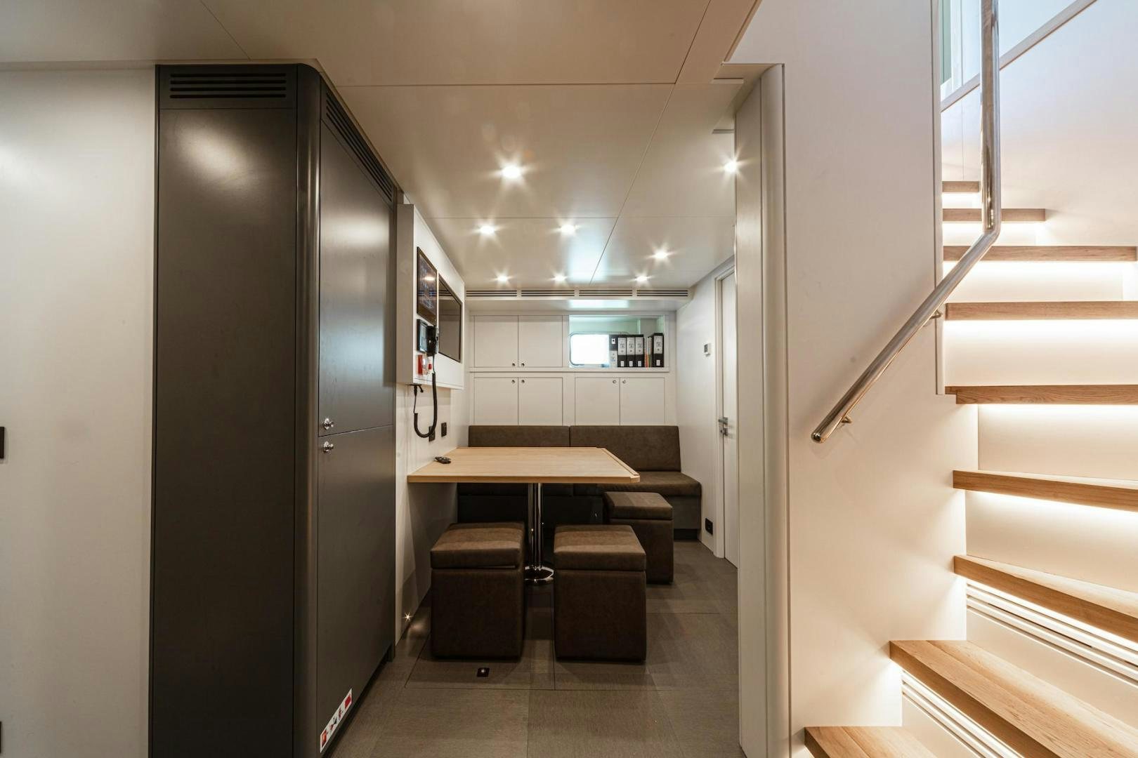 a hallway with a desk and a door aboard ATOM Yacht for Sale