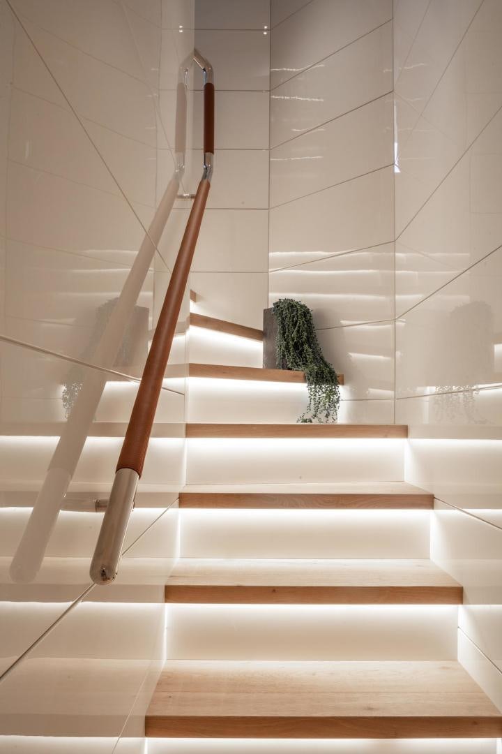 a cat sitting on a staircase aboard ATOM Yacht for Sale