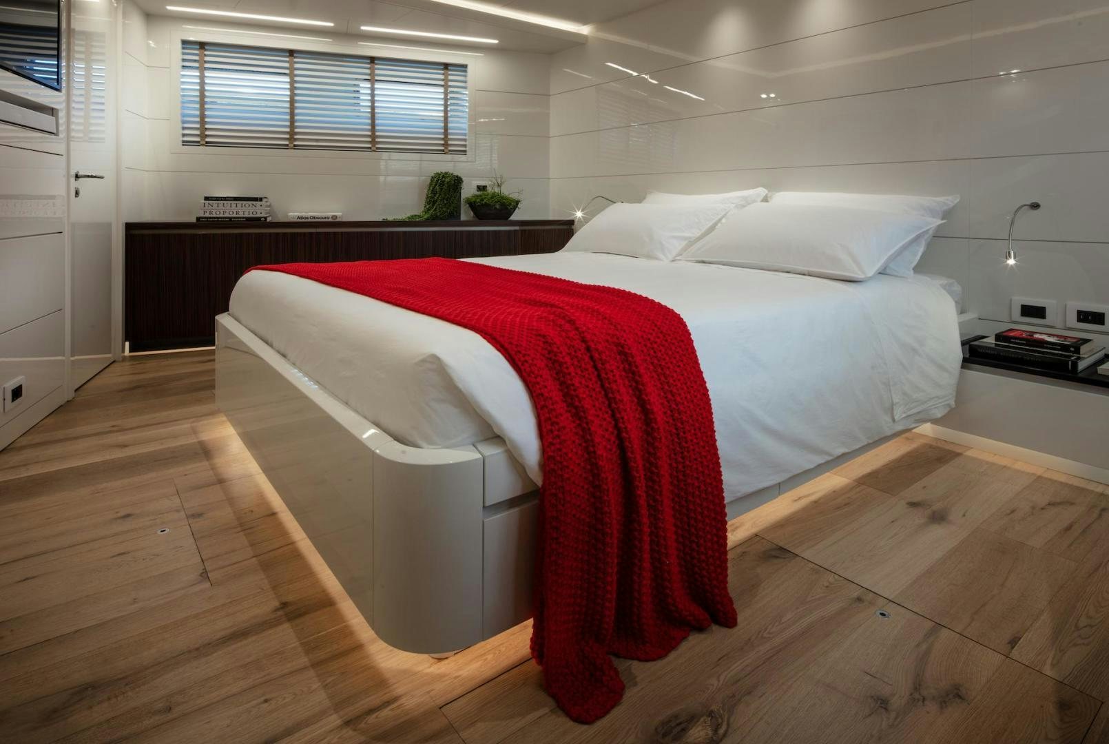 a bed in a room aboard ATOM Yacht for Sale