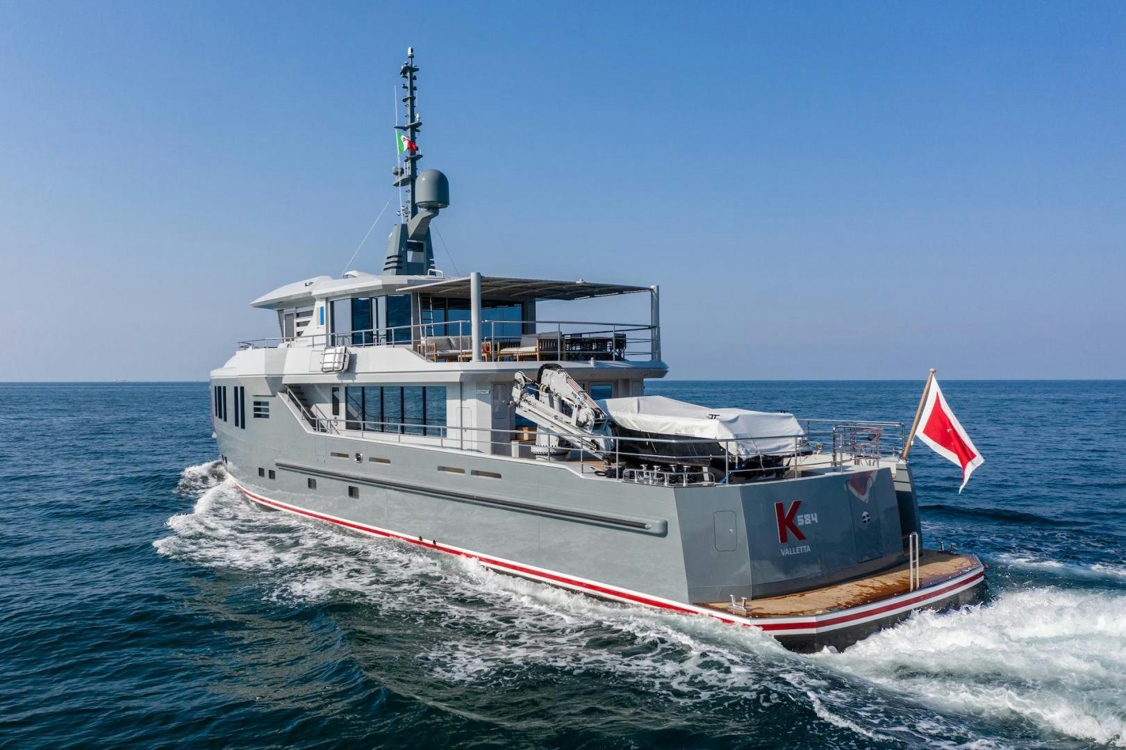 a large boat on the water aboard ATOM Yacht for Sale