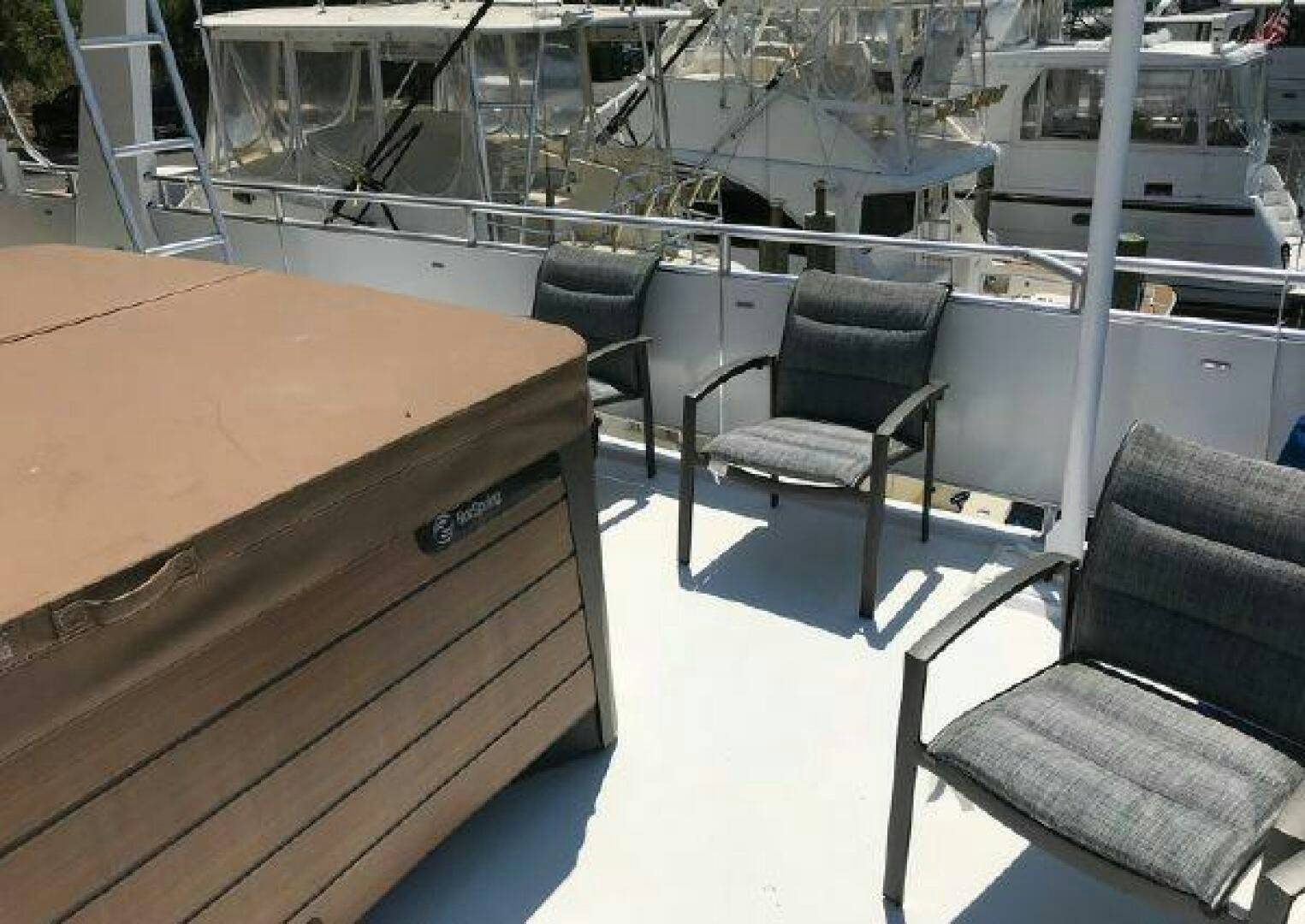 a table and chairs on a deck aboard ST. SOMEWHERE Yacht for Sale