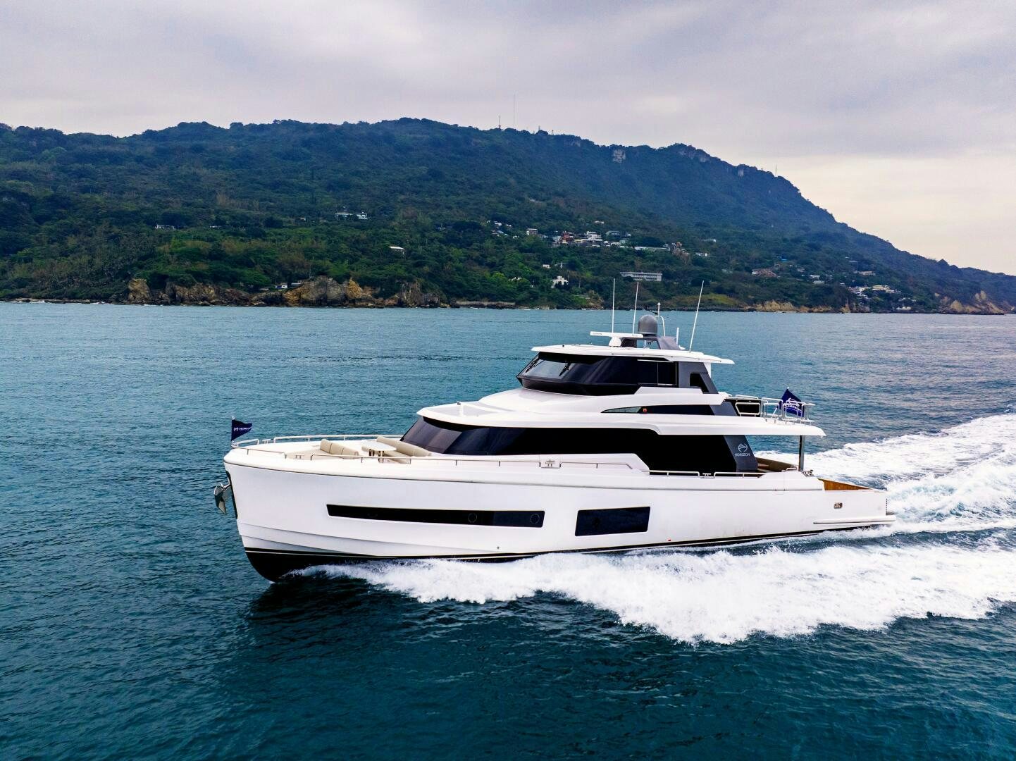 a white yacht on water aboard V77S 610 Yacht for Sale