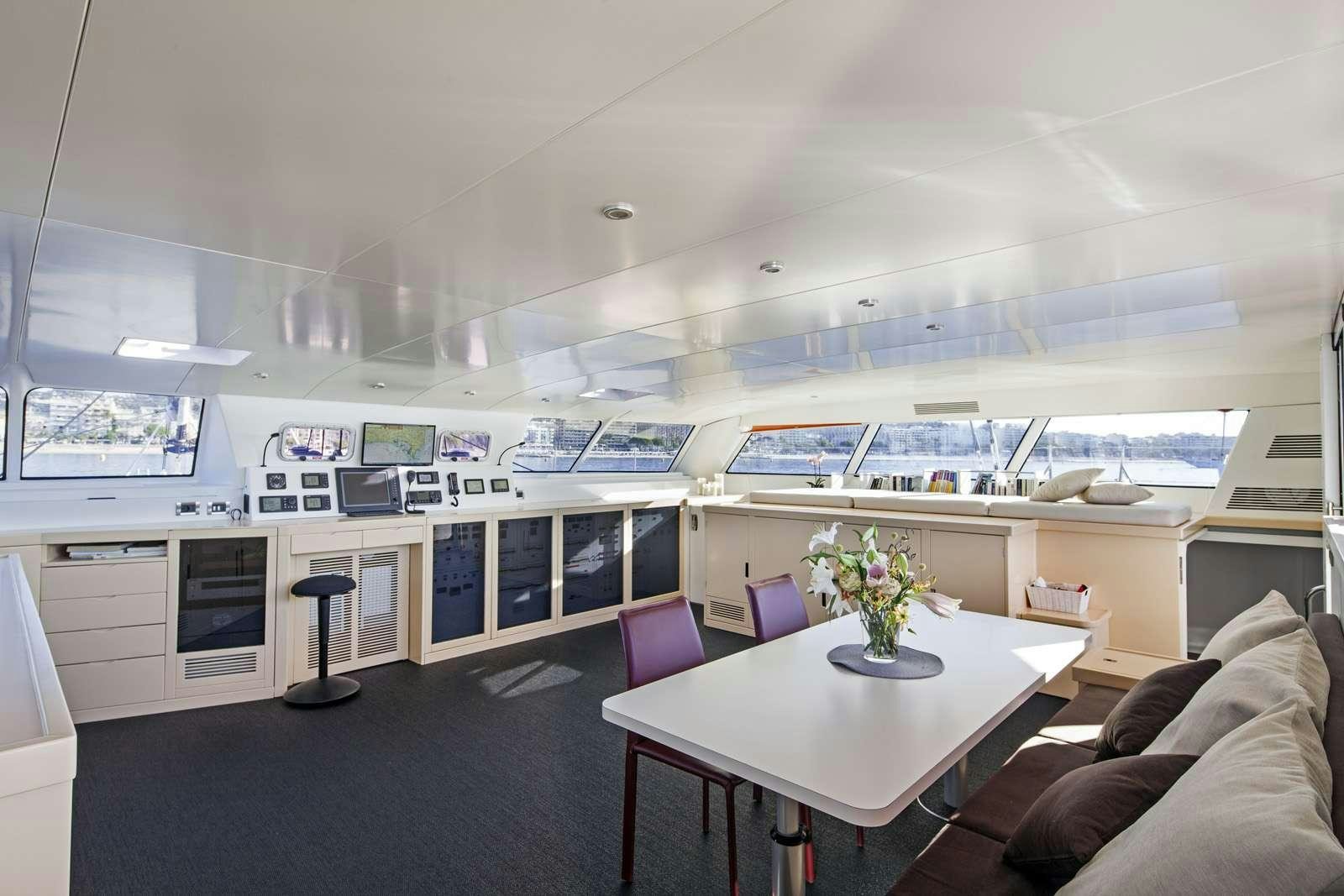 a room with a table and chairs aboard TAJ Yacht for Charter