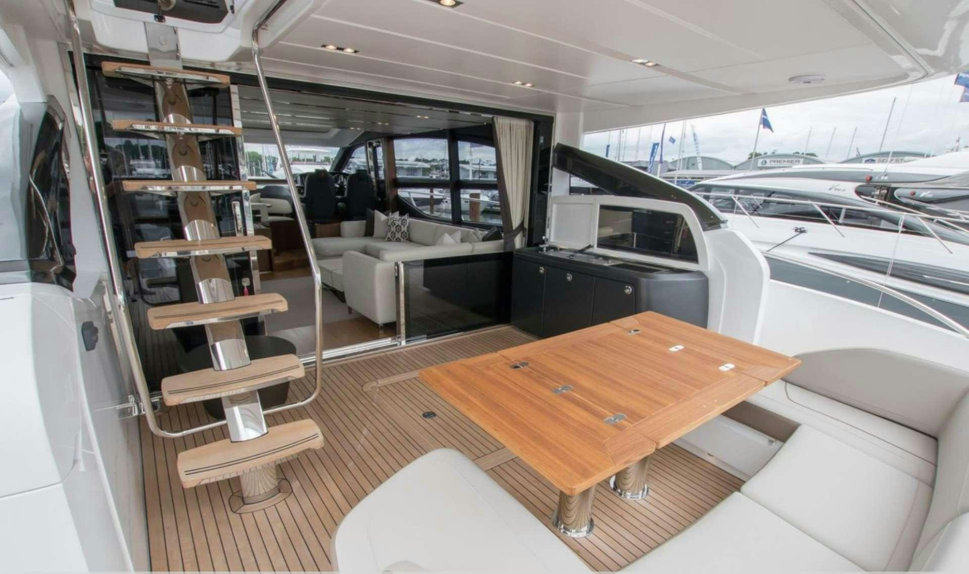 a room with a table and chairs aboard NELENA Yacht for Charter