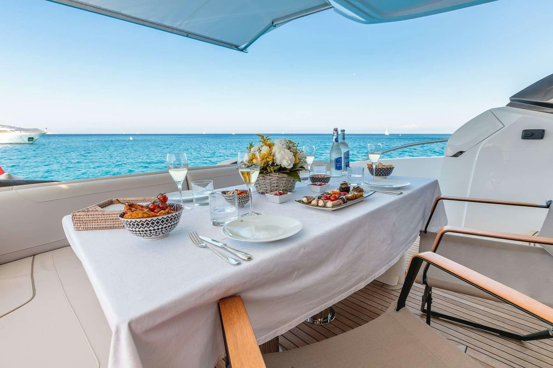 a table with food and drinks on it aboard NELENA Yacht for Charter