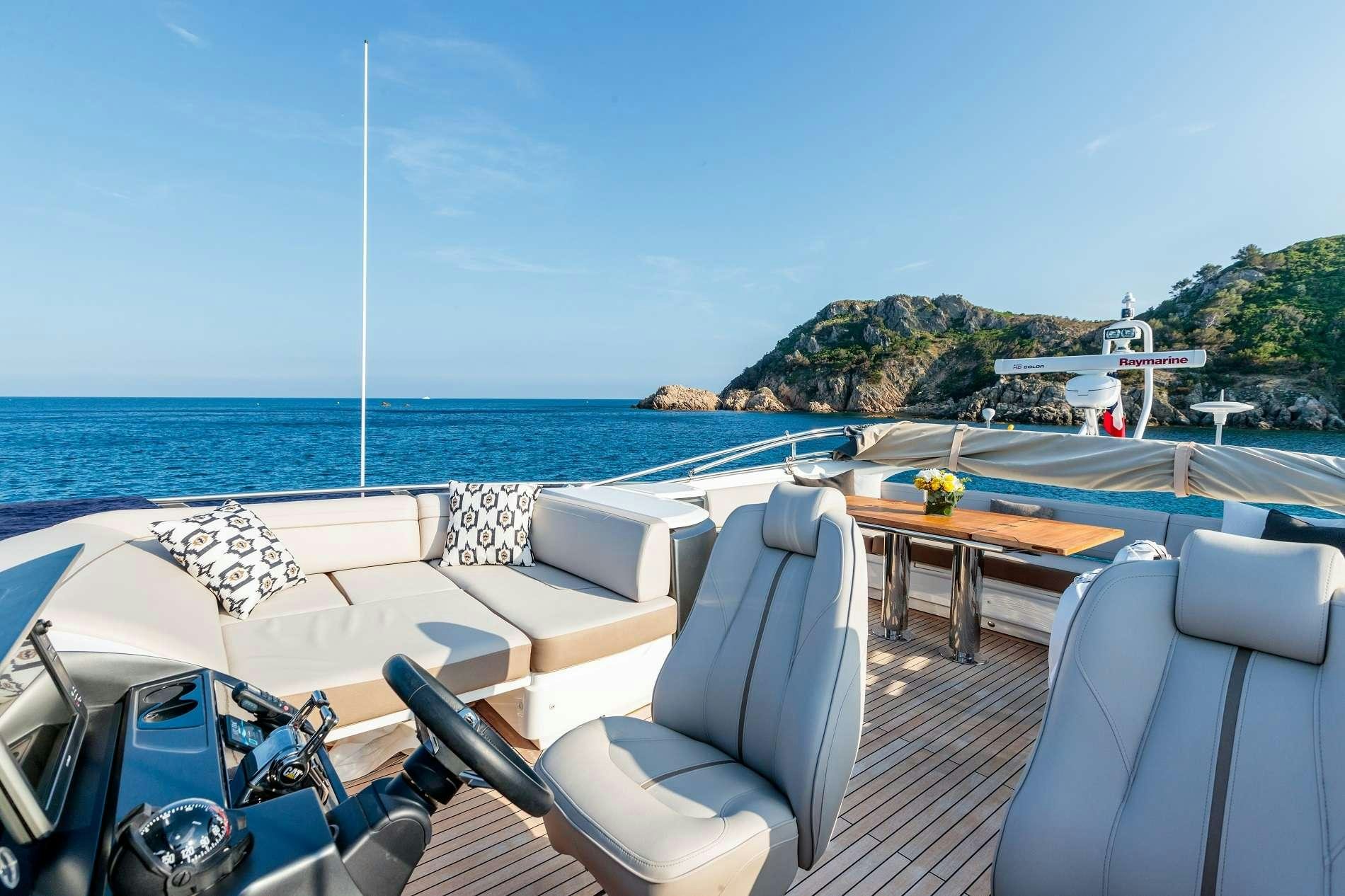 a lounge area with chairs and tables on it aboard NELENA Yacht for Charter
