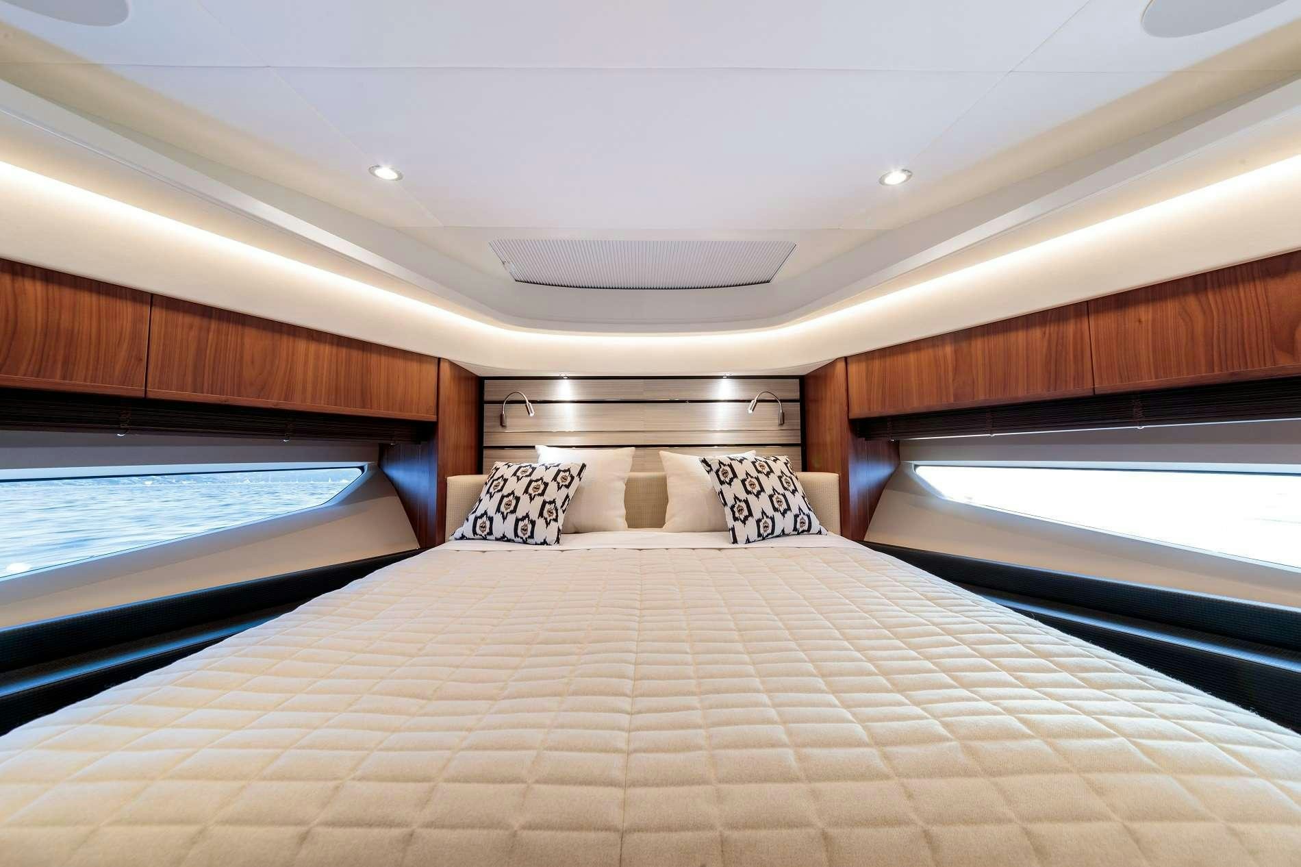a bed with a white bed spread aboard NELENA Yacht for Charter