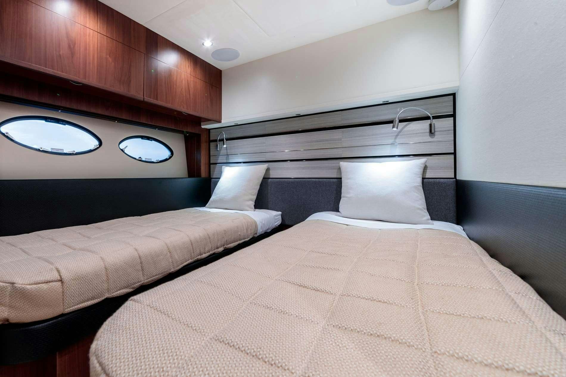 a bed with a white comforter aboard NELENA Yacht for Charter