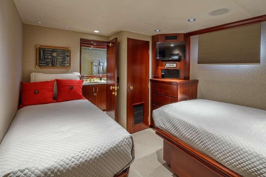 a couple of beds in a hotel room aboard BLACKWOOD Yacht for Charter