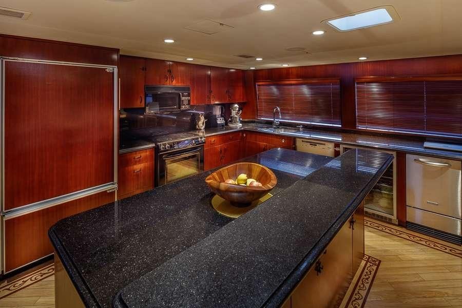 a kitchen with black counter tops aboard BLACKWOOD Yacht for Charter