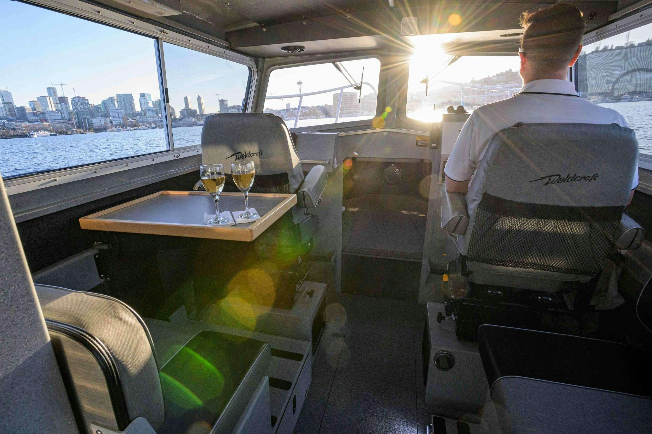 a person sitting at a table on a boat aboard BLACKWOOD Yacht for Charter