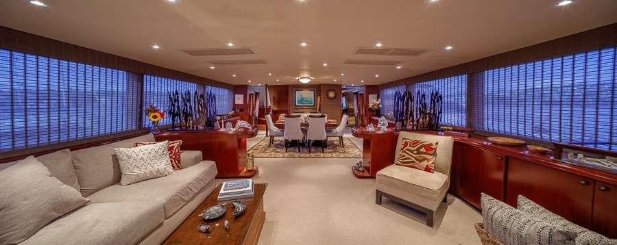 a living room with a couch and a table aboard BLACKWOOD Yacht for Charter