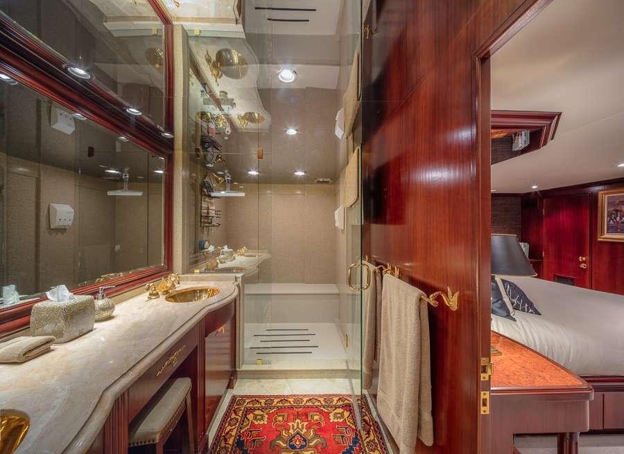 a room with a bed and a mirror aboard BLACKWOOD Yacht for Charter