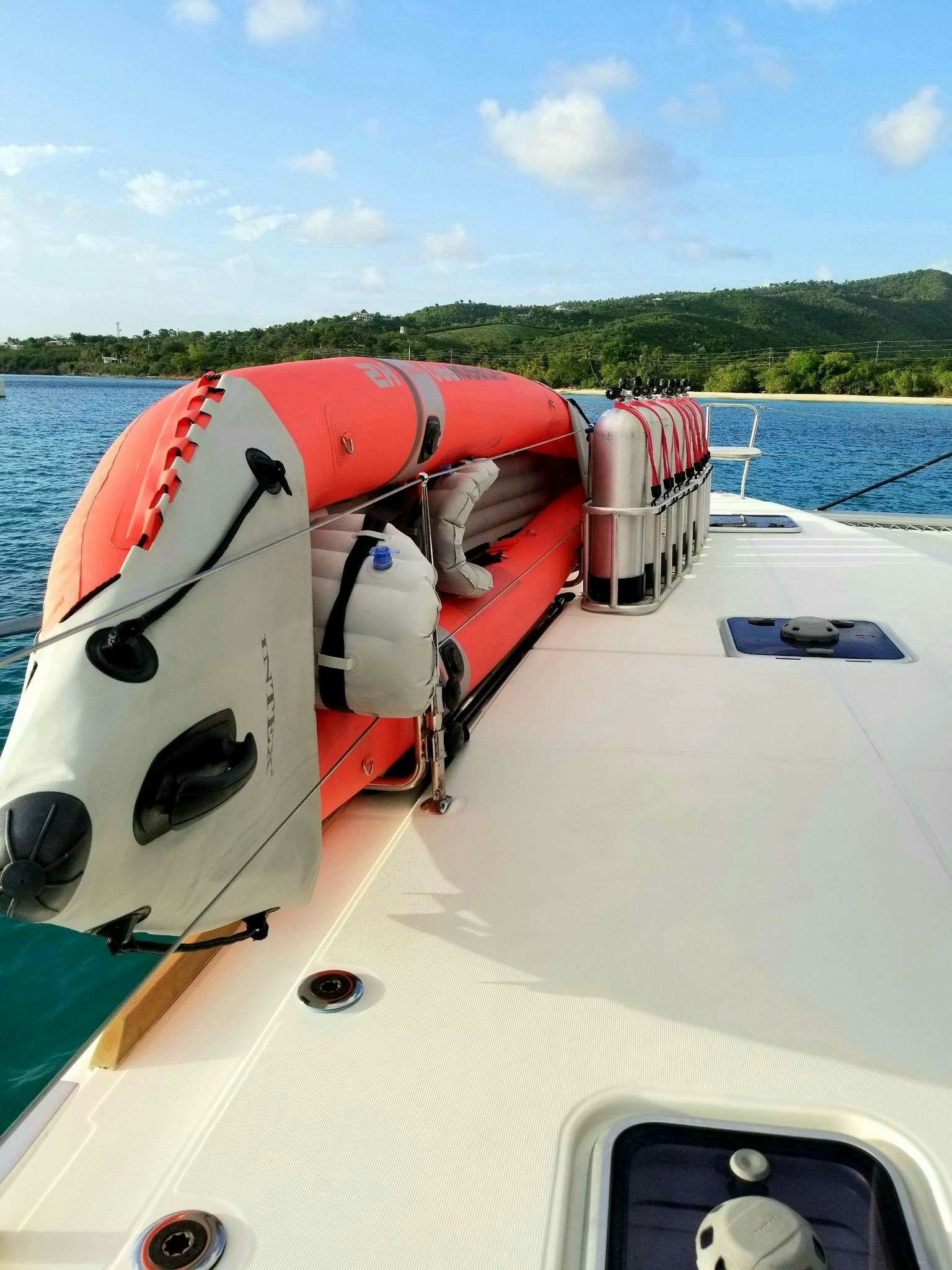 a boat with a motor attached to it aboard TIME OUT Yacht for Charter