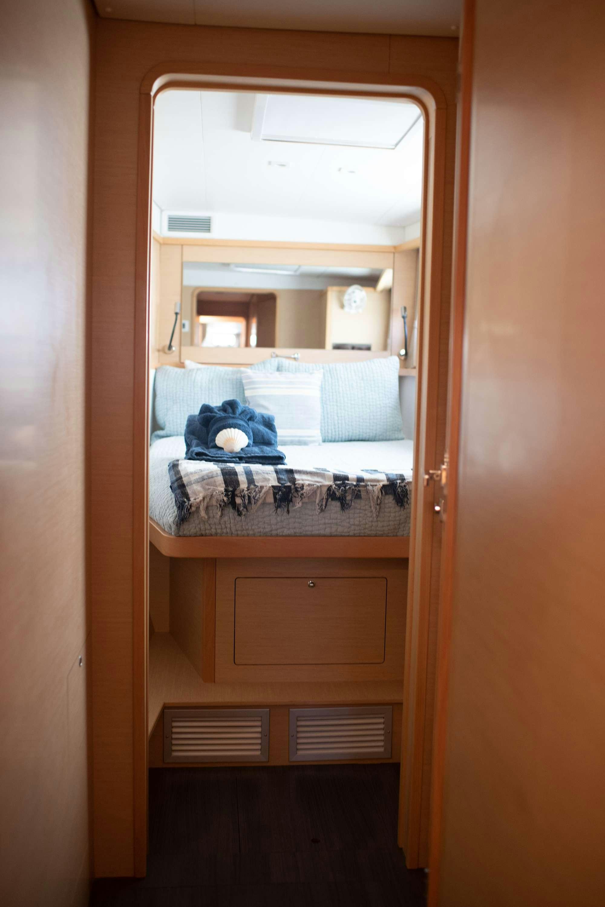 a closet with a bed and a shelf aboard TIME OUT Yacht for Charter