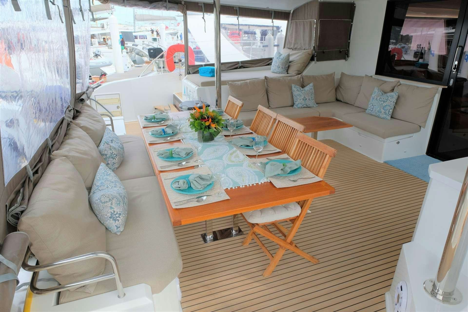 a living room with a couch and a table aboard PORT TO VINO Yacht for Charter
