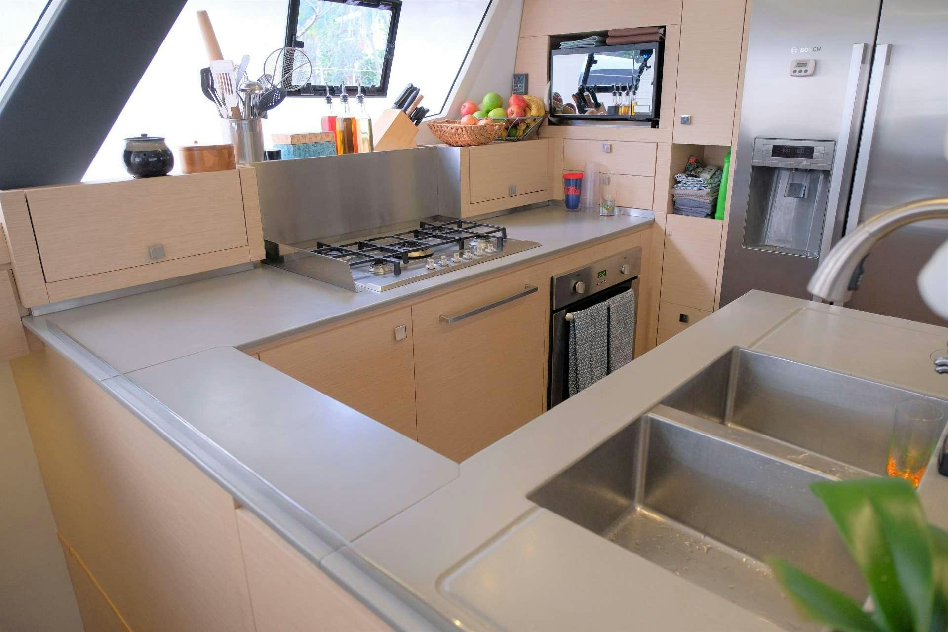 a kitchen with a sink and a microwave aboard PORT TO VINO Yacht for Charter