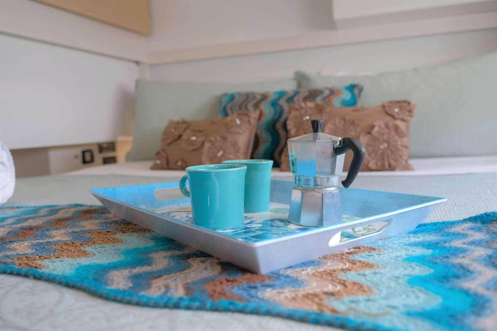 a table with cups and a tray aboard PORT TO VINO Yacht for Charter