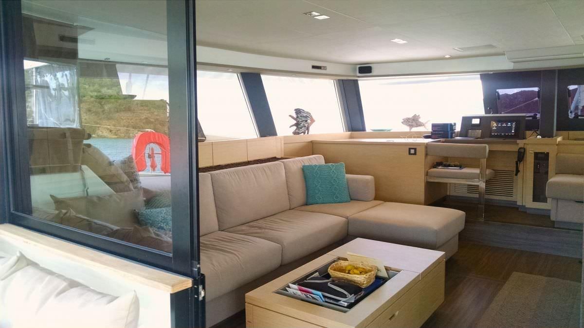 a living room with a couch and a tv aboard PORT TO VINO Yacht for Charter