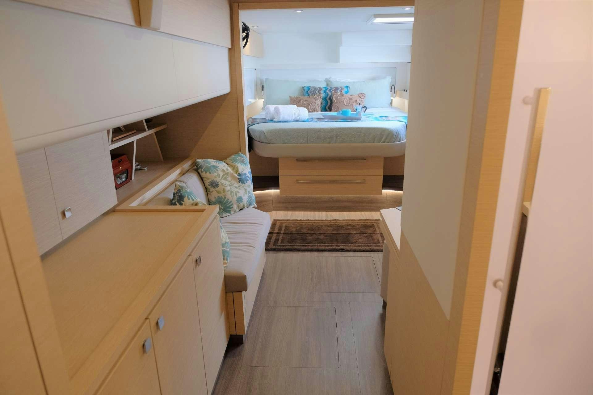 a room with a bed and a dresser aboard PORT TO VINO Yacht for Charter