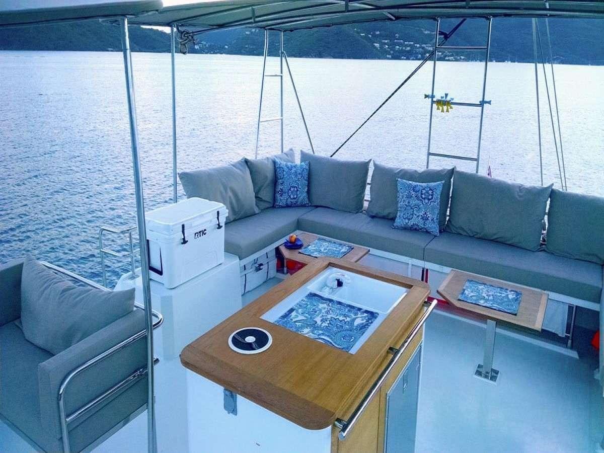 a living room with a couch and a table aboard PORT TO VINO Yacht for Charter