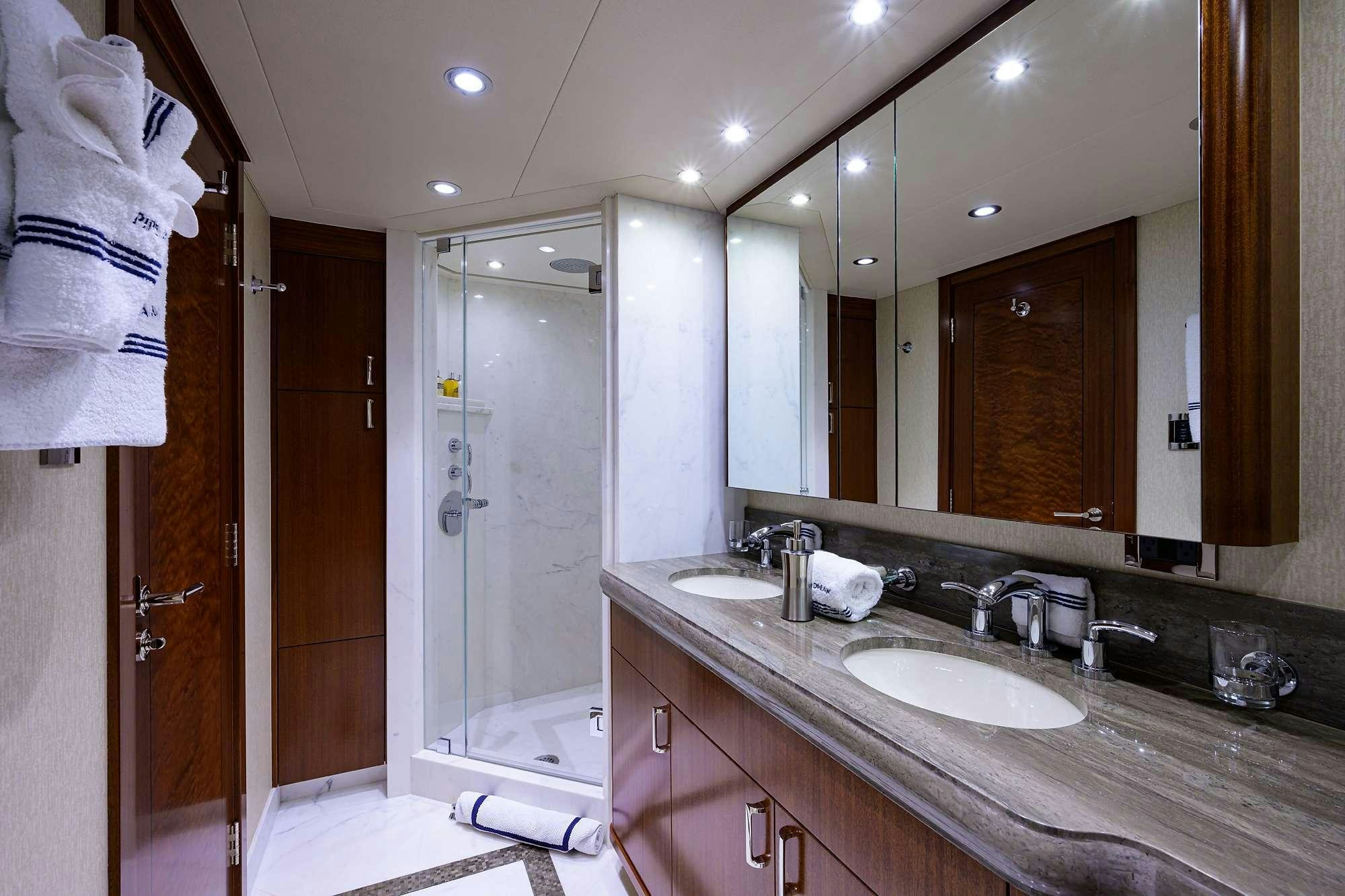 a bathroom with a large mirror aboard LADY JJ Yacht for Charter