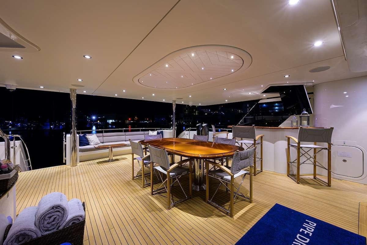 a large room with tables and chairs aboard LADY JJ Yacht for Charter