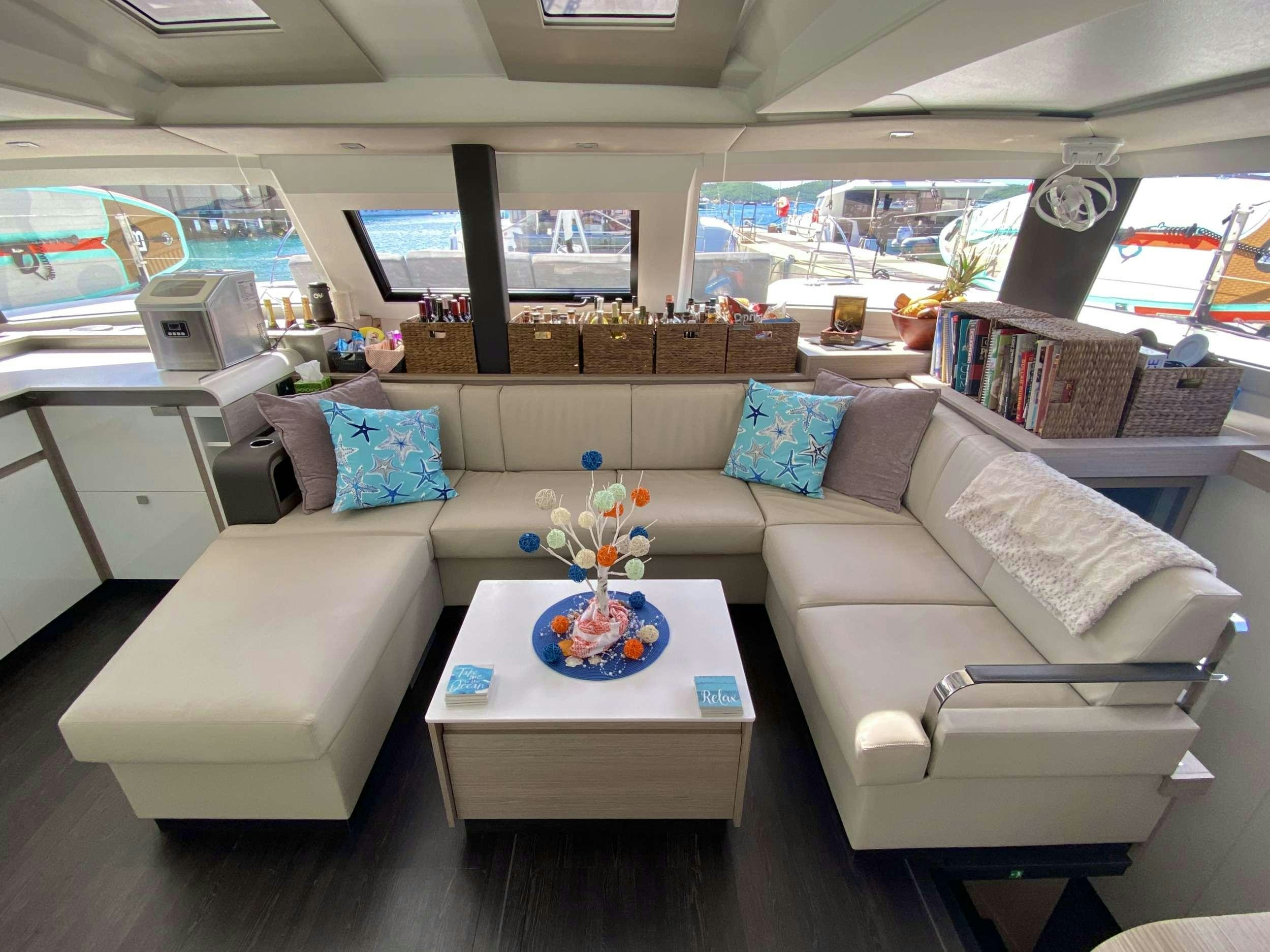 a living room with a couch and a coffee table aboard O.V. Yacht for Charter