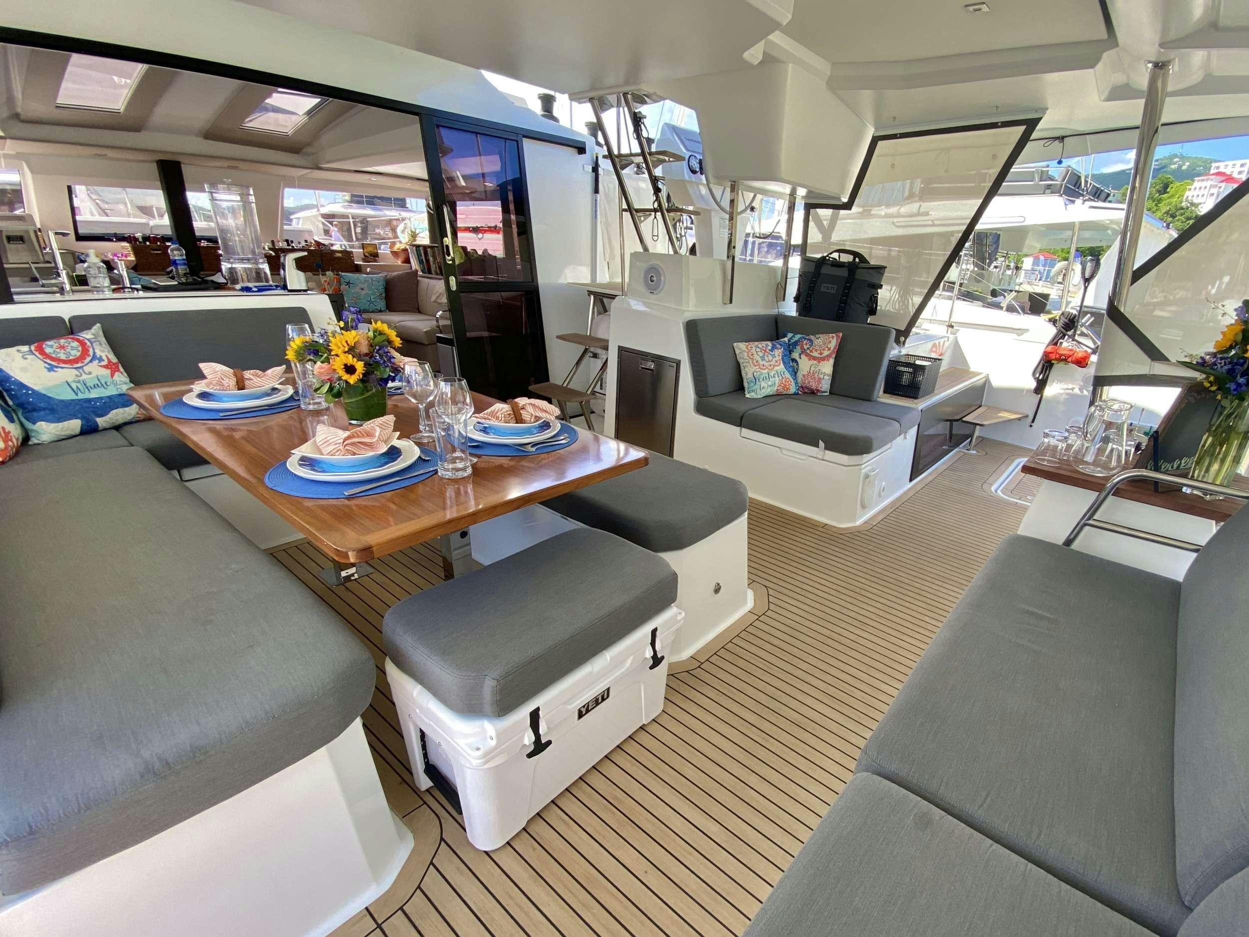 a living room with a couch and a coffee table aboard O.V. Yacht for Charter