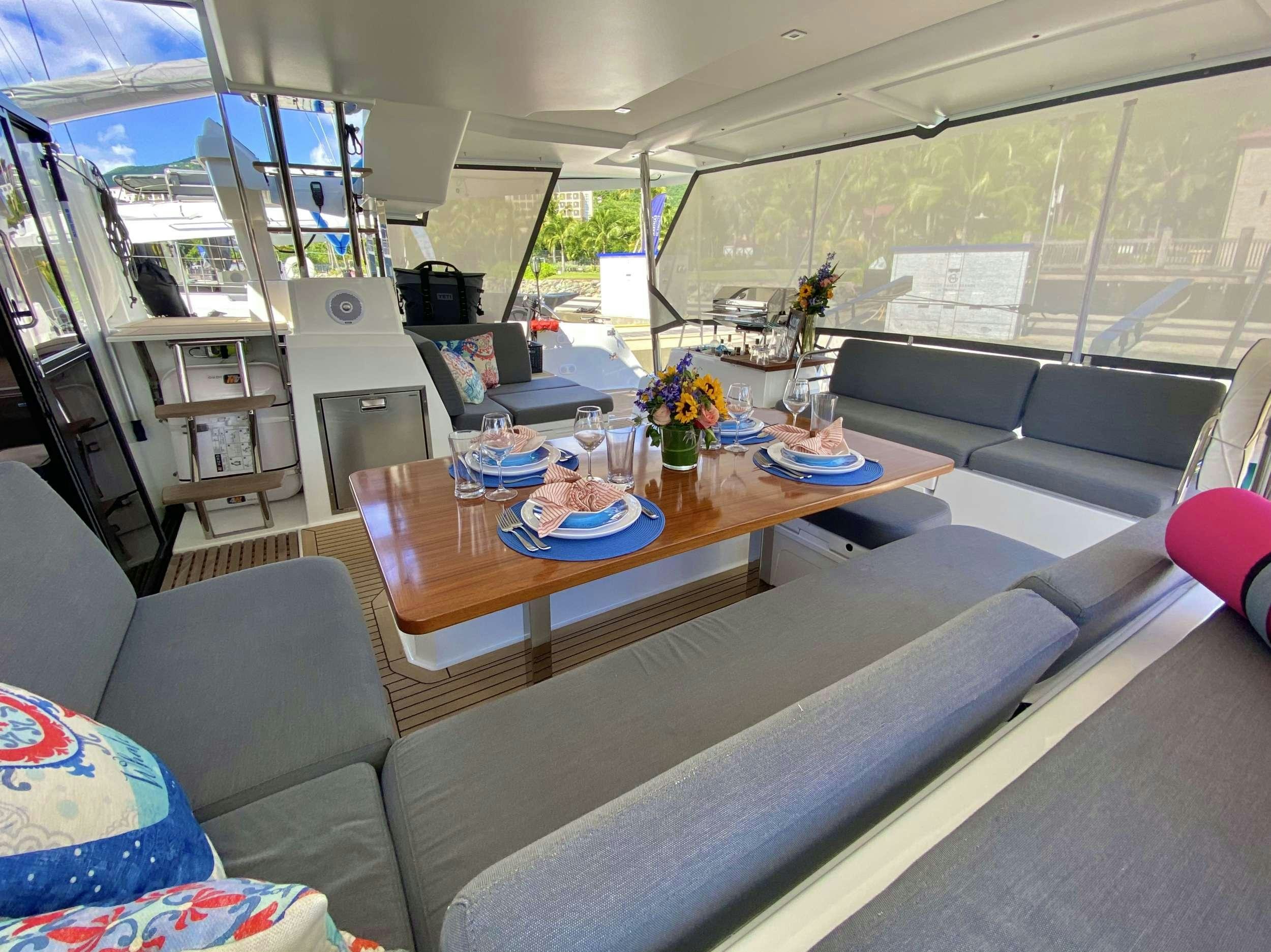 a living room with a couch and a coffee table aboard O.V. Yacht for Charter
