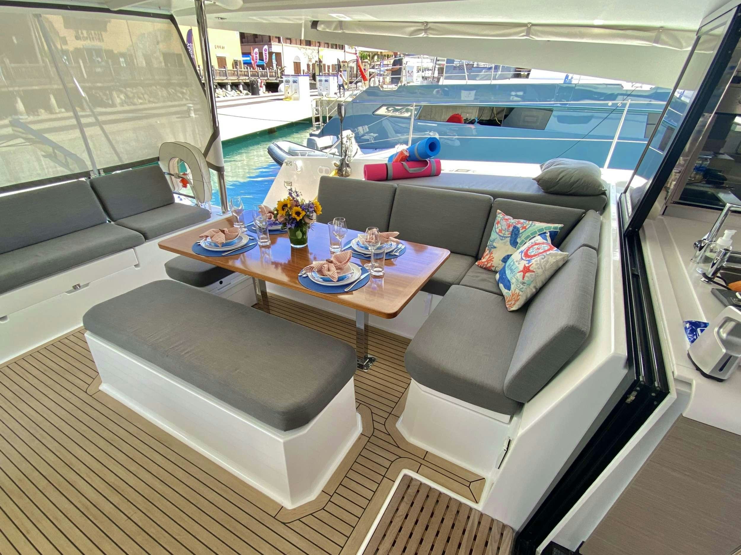 a living room with a couch and a table aboard O.V. Yacht for Charter