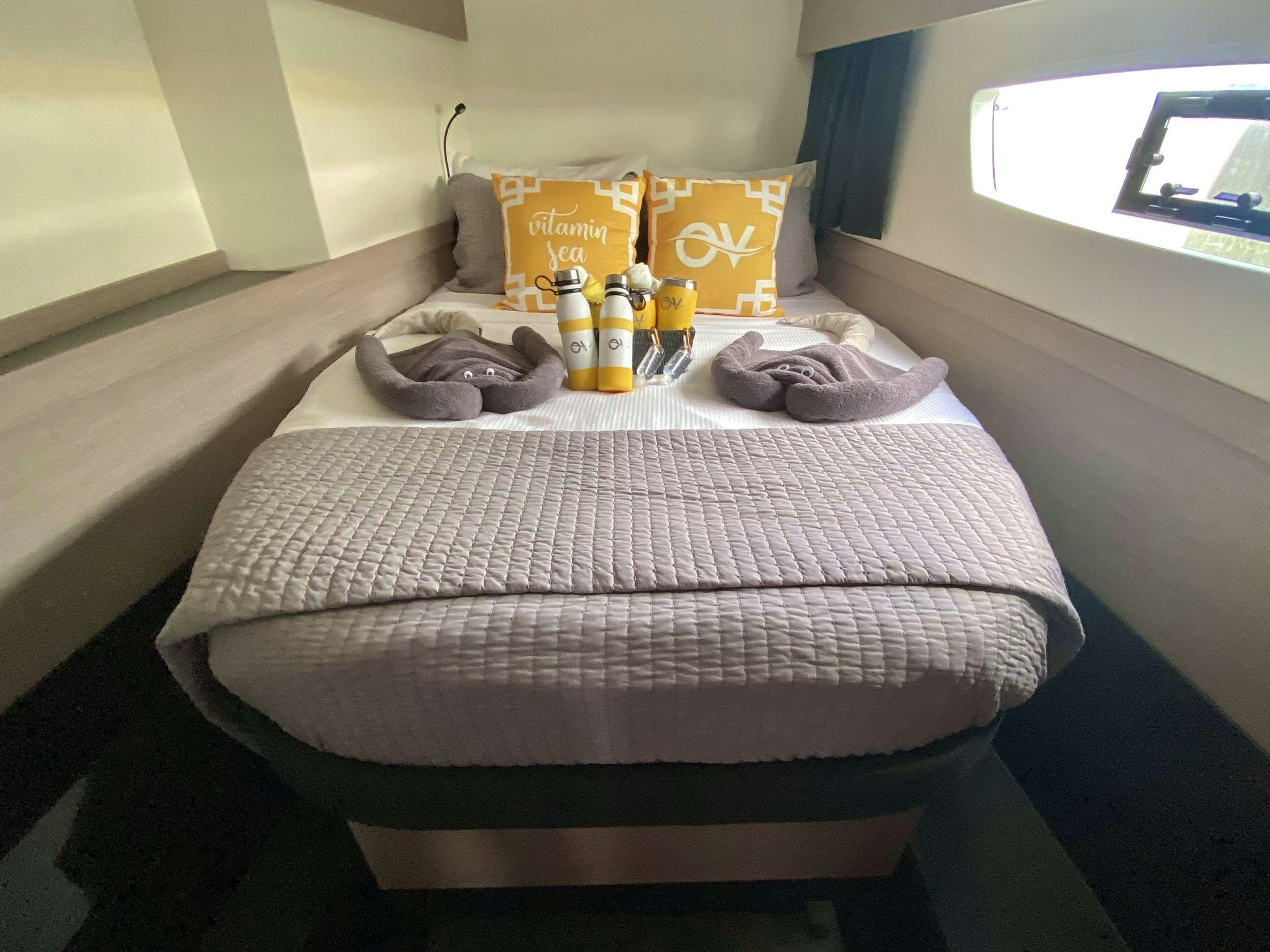 a bed with a tray of food and drinks on it aboard O.V. Yacht for Charter