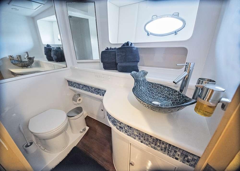 a bathroom with a sink and a toilet aboard COOL BREEZE 65 Yacht for Charter