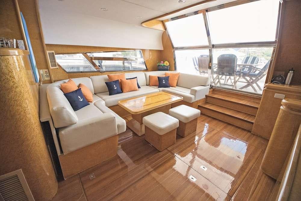 a living room with a couch and a table aboard COOL BREEZE 65 Yacht for Charter