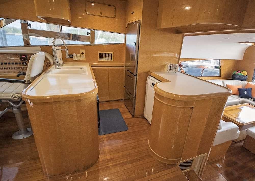 a kitchen with a sink and a large trash can aboard COOL BREEZE 65 Yacht for Charter