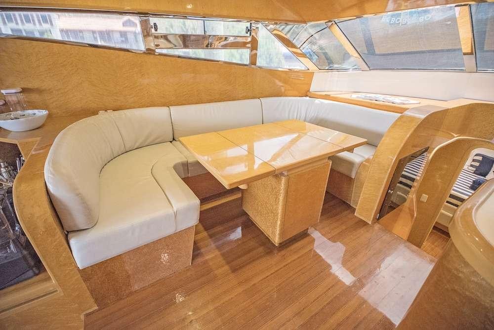 a room with a couch and a table aboard COOL BREEZE 65 Yacht for Charter