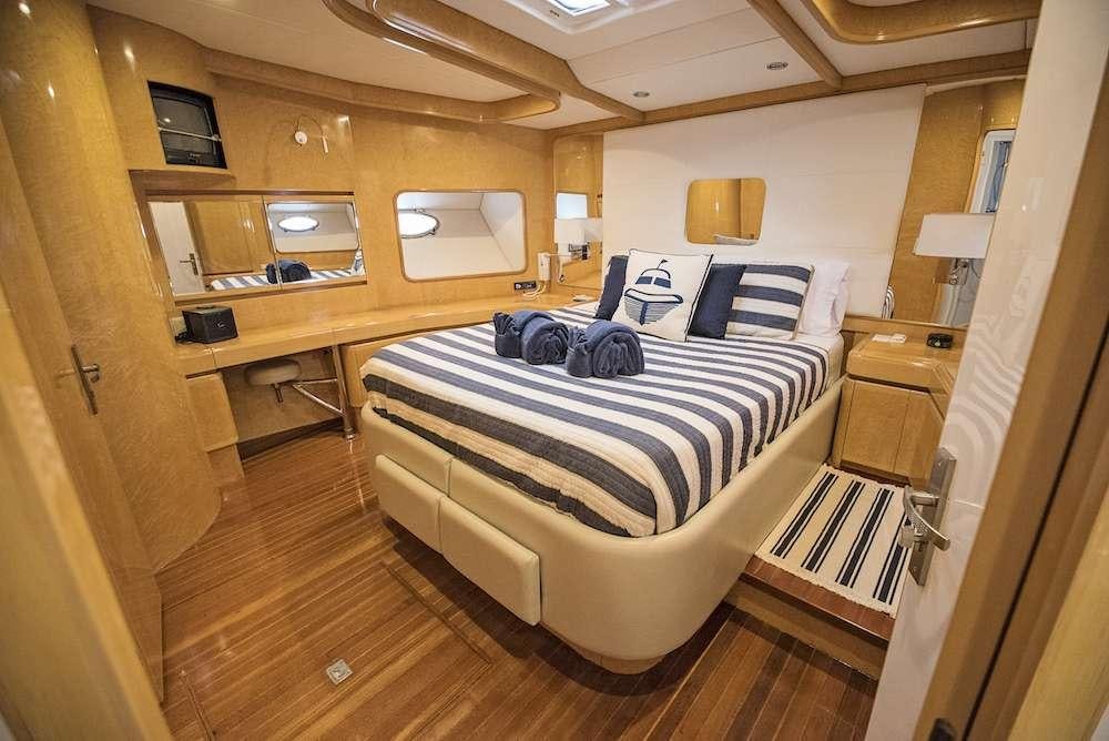 a bedroom with a bed aboard COOL BREEZE 65 Yacht for Charter