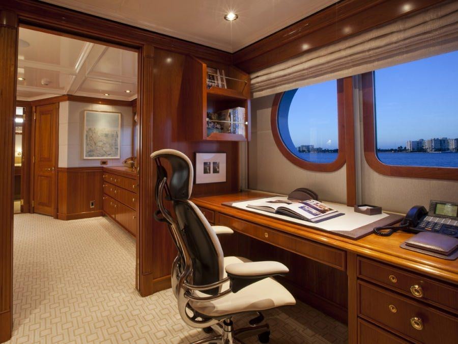 a room with a desk and a window aboard LEVERAGE Yacht for Charter