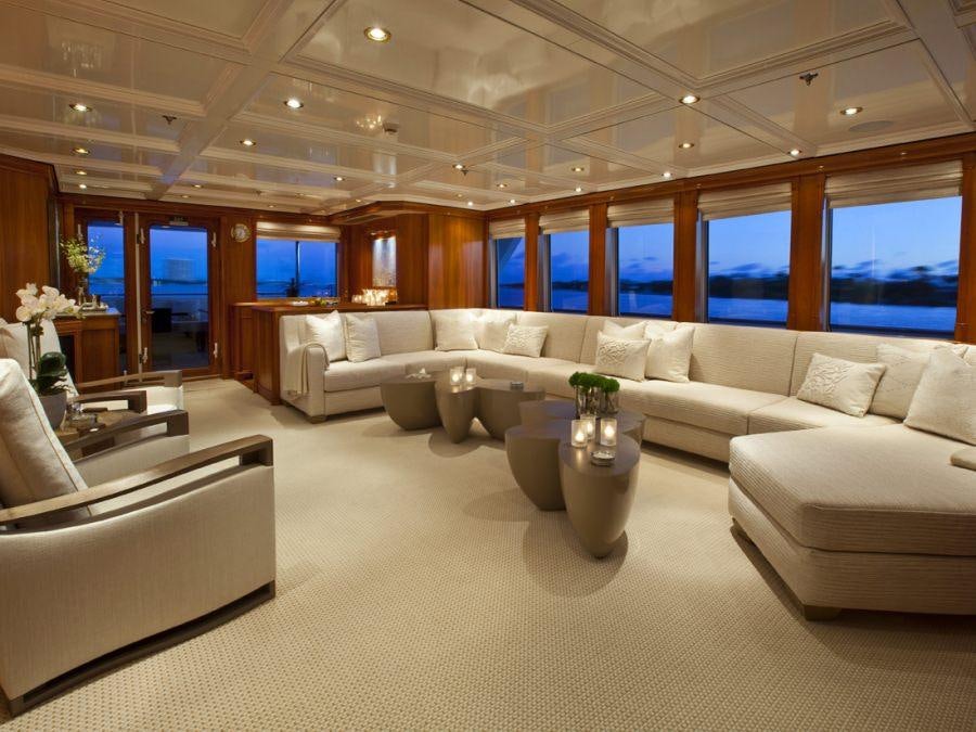 a living room with a large white couch and a table aboard LEVERAGE Yacht for Charter