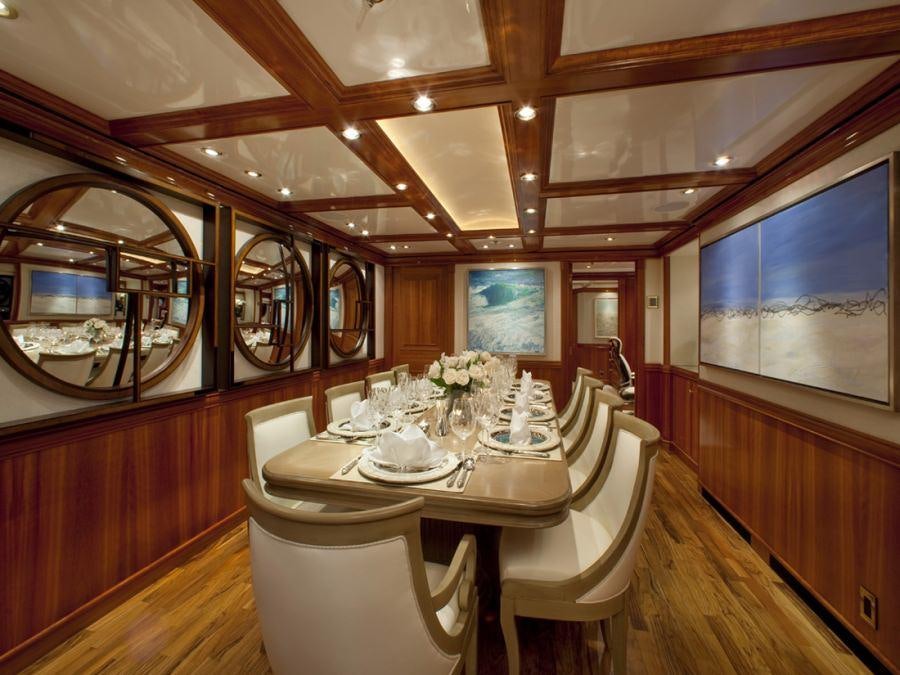 a dining room with a table and chairs aboard LEVERAGE Yacht for Charter