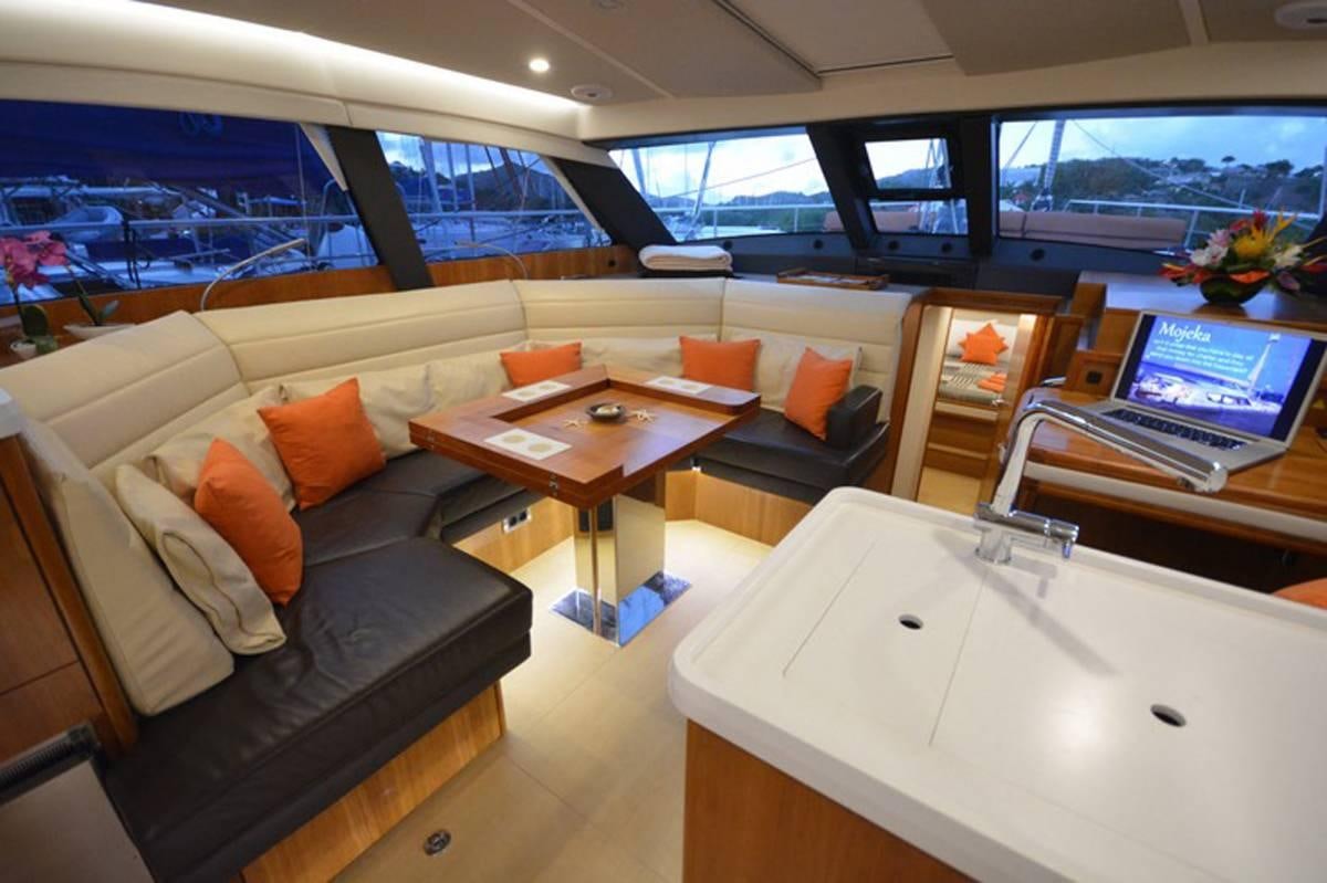 a living room with a couch and a table aboard MOJEKA  Yacht for Charter